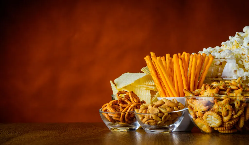 different salty treats - popcorn, crackers, pretzels, biscuits