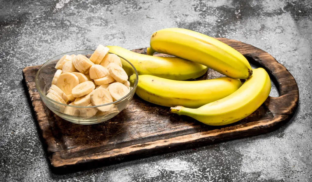 fresh bananas with pieces of sliced banans in a bowl 