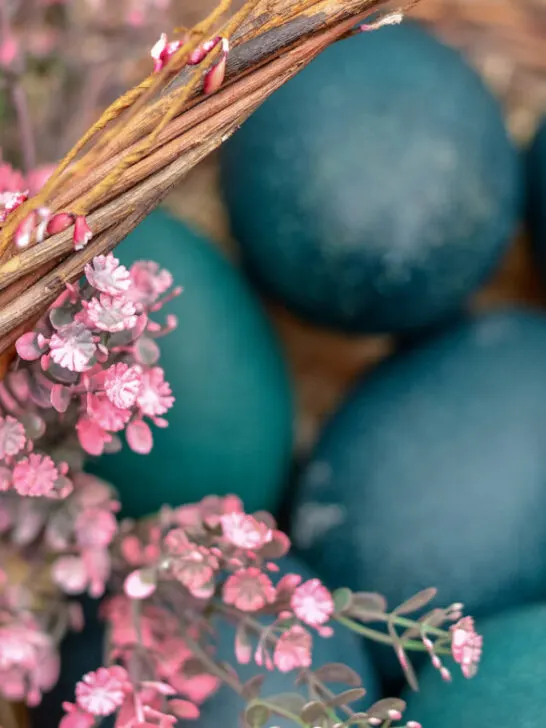 green emu egg in a decorated basket