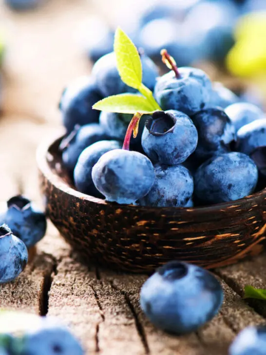 freshly picked blueberries on a wooden bowl